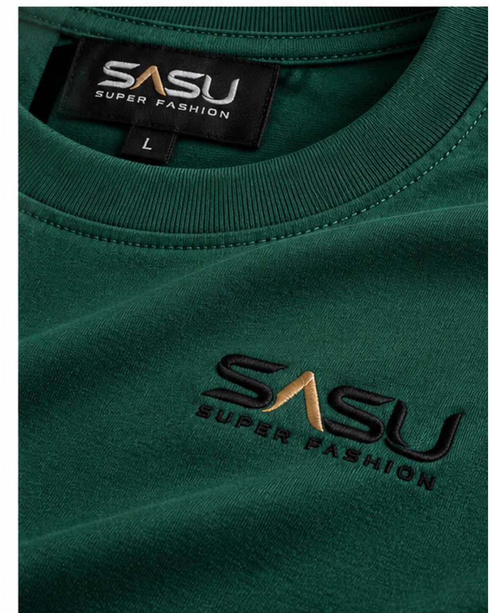 Close-up of the black and gold embroidered logo and ribbed collar on the forest green T-shirt