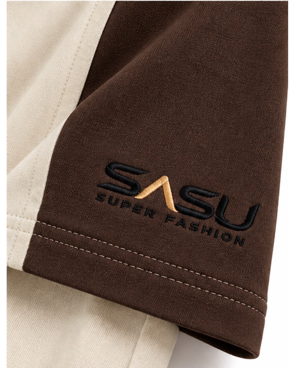 Close-up of the black and gold embroidered logo on the dark brown sleeve
