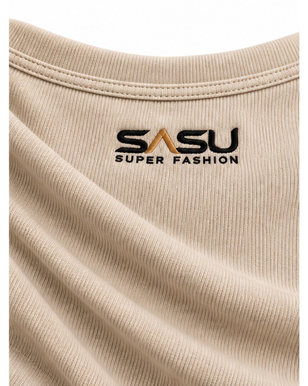 Close-up of the black and gold embroidered logo at the back neckline of the beige top